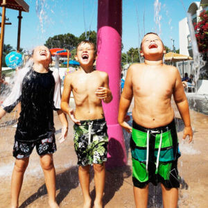 Howard Johnson Anaheim hotel Castaway Cove rain tree with 3 boys playing