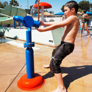 child playing with water squirter at Castaway Cove