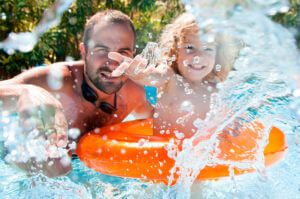 father and child in pool