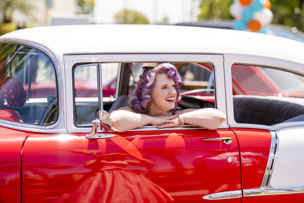 one of Howard Johnson Anaheim's retro friends poses in a retro car