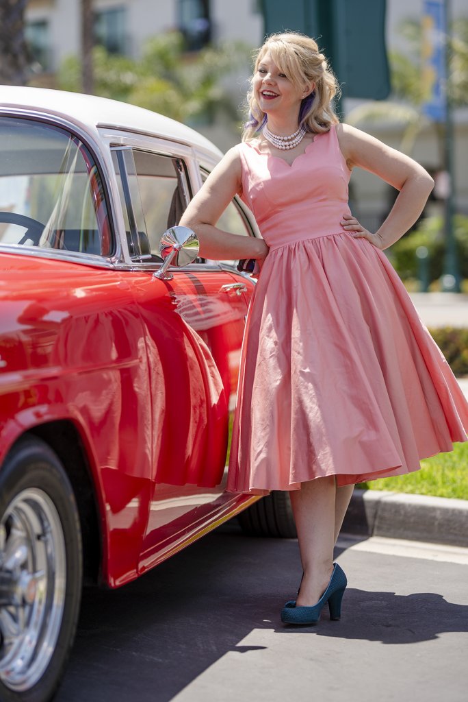 one of Howard Johnson Anaheim's retro friends poses near a retro car