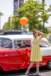 one of Howard Johnson Anaheim's retro friends poses near a retro car