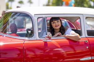 one of Howard Johnson Anaheim's retro friends poses in a retro car