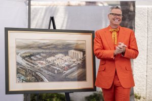 Charles Phoenix poses next to the original architectural rendering of the hotel