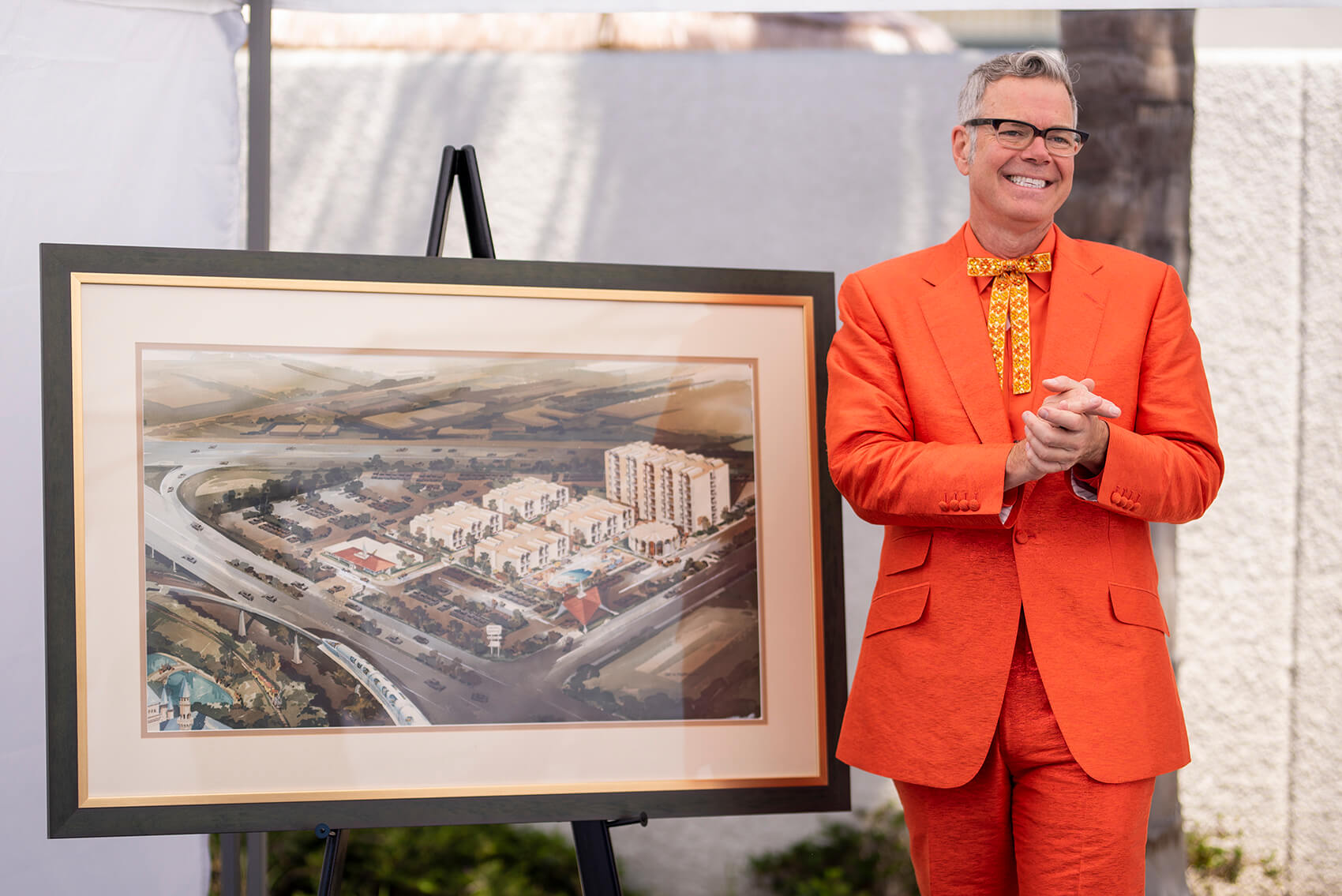 Charles Phoenix poses next to the original architectural rendering of the hotel