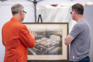 Charles Phoenix and HoJo Anaheim General Manager, Jonathan Whitehead, examining the original architectural rendering of the hotel