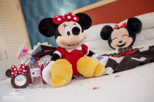 Minnie Mouse themed items sit on a hotel room bed