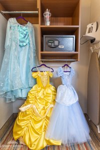 Disney princess dresses hanging up in a hotel room wardrobe