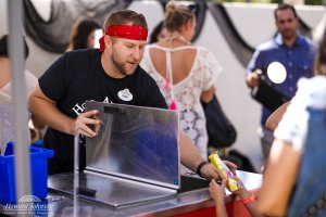 a man passes a frozen treat to a child