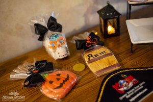 a collection of pirate and halloween themed cookies lay on a table