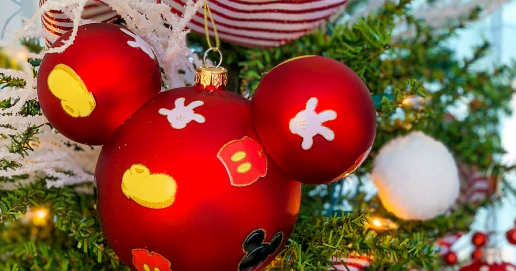 a Mickey Mouse themed ornament on a Christmas tree