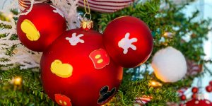 a Mickey Mouse themed ornament on a Christmas tree