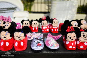 Minnie and Mickey Mouse slippers and shoes are displayed on a table