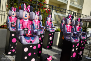 Minnie Mouse car seats are displayed on polka dot stands