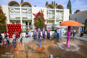 children and parents are pictured in the Howard Johnson Anaheim water park with a polka dot backdrop and props for National Polka Dot Day