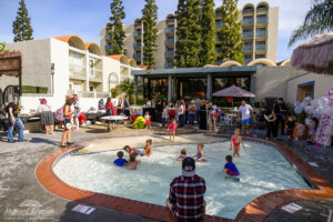 Children and parents gather around and play in the shallow pool at Howard Johnson Anaheim hotel