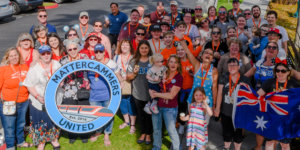 a group of people pose for a picture with a sign, identifying them as Mattercammers United