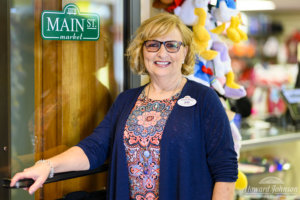 A Howard Johnson Anaheim employee named Jeri poses outside the Main St. Market