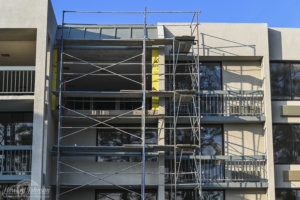 Building 2 undergoes a major transformation with scaffolding outside at Howard Johnson Anaheim.