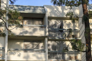 Building 2 undergoes a major transformation with paint sheets covering the balcony patio doors outside at Howard Johnson Anaheim.