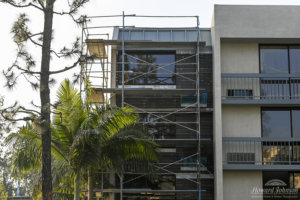 Building 2 undergoes a major transformation with scaffolding outside at Howard Johnson Anaheim.